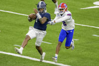 Georgia Southern quarterback Shai Werts (1) scores his second touchdown, the team's third, as Louisiana Tech defensive back Zach Hannibal (2) defends during the first half of the New Orleans Bowl NCAA college football game in New Orleans, Wednesday, Dec. 23, 2020. (AP Photo/Matthew Hinton)