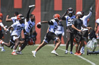 Cleveland Browns defensive back Greg Newsome II celebrates with teammates after an interception in 7 on 7 drills during an NFL football practice at the team's training facility, Thursday, June 17, 2021, in Berea, Ohio. (AP Photo/David Dermer)