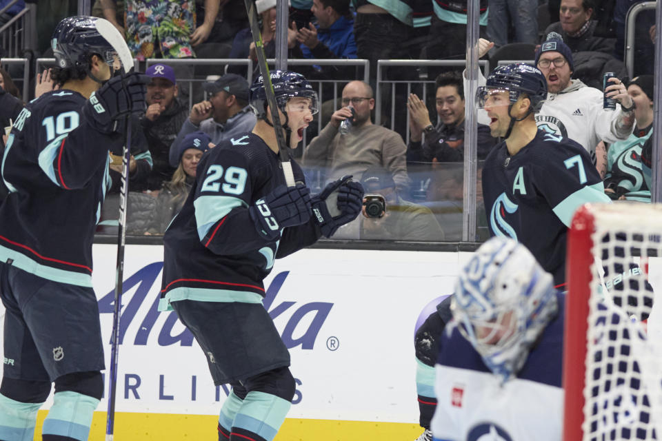 Seattle Kraken right wing Jordan Eberle (7) celebrates his goal with defenseman Carson Soucy, center Matty Beniers after scoring against the Winnipeg Jets during the second period of an NHL hockey game, Sunday, Dec. 18, 2022, in Seattle. (AP Photo/John Froschauer)
