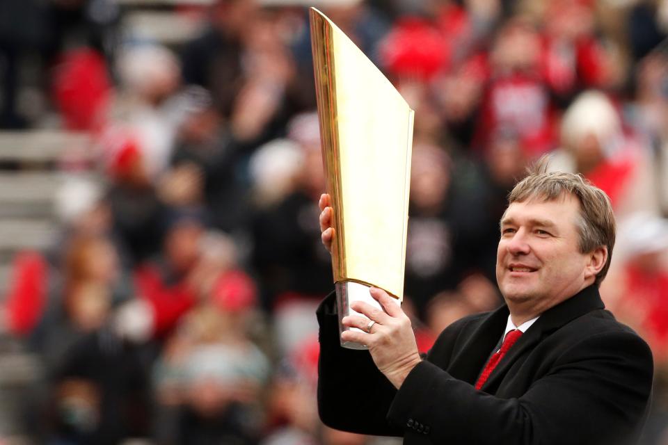 Jan 15, 2022; Athens, GA, USA; Georgia coach Kirby Smart hoists the CFP college football playoff national championship trophy during a celebration at Sanford Stadium in Athens, Ga., on Saturday, Jan. 15, 2022. Mandatory Credit: Joshua L. Jones-USA TODAY Sports