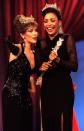 ATLANTIC CITY, UNITED STATES: Miss South Carolina Kimberly Clarice Aiken, 18, (R) is shown to the runway after being crowned Miss America by last year's Miss America Leanza Cornett 18 September 1993 in New Jersey. Aiken says she plans to spend her year as Miss America working to educate the homeless. (Photo credit should read TIM CLARY/AFP via Getty Images)