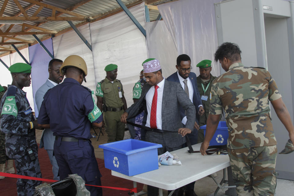 Somali lawmakers are checked by security forces as they arrive to cast their vote in the presidential election, at the Halane military camp which is protected by African Union peacekeepers, in Mogadishu, Somalia Sunday, May 15, 2022. Legislators in Somalia are meeting Sunday to elect the country's president in the capital, Mogadishu, which is under lockdown measures aimed at preventing deadly militant attacks. (AP Photo/Farah Abdi Warsameh)