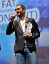 DUBAI, UNITED ARAB EMIRATES - DECEMBER 16: Actor Amr Waked with the Muhr Arab Feature Best Actor award on stage during the Closing Ceremony on day eight of the 9th Annual Dubai International Film Festival held at the Madinat Jumeriah Complex on December 16, 2012 in Dubai, United Arab Emirates. (Photo by Gareth Cattermole/Getty Images for DIFF)