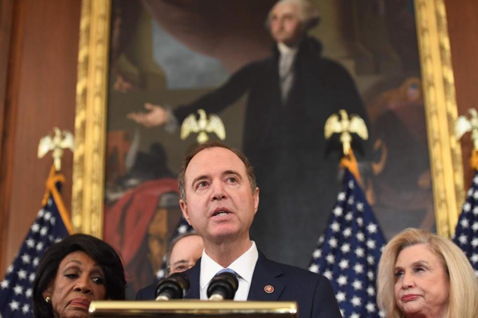 Adam Schiff speaks, in front of a portrait of George Washington.