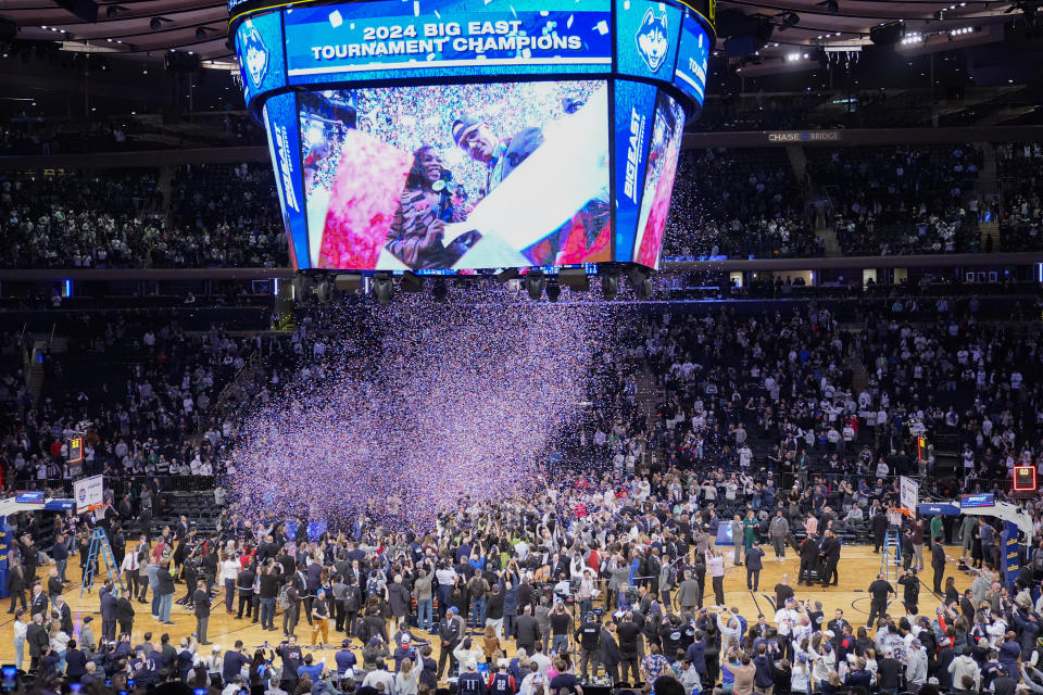 UConn head coach Dan Hurley is displayed on the Jumbotron, right, while being interviewed during the Big East trophy ceremony after defeating Marquette in the NCAA college basketball game championship of the Big East Conference tournament, Saturday, March 16, 2024, in New York. UConn won 73-57. (AP Photo/Mary Altaffer)