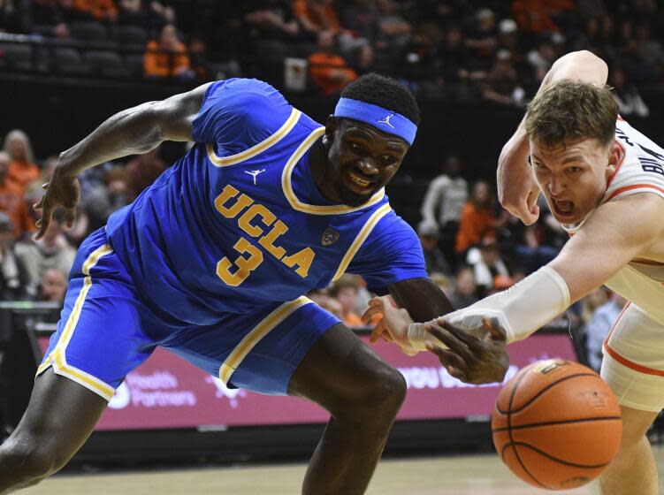 Oregon State forward Tyler Bilodeau (34) knocks the ball away from UCLA forward Adem Bona (3) during the second half of an NCAA college basketball game Thursday, Dec. 28, 2023, in Corvallis, Ore. (AP Photo/Mark Ylen)