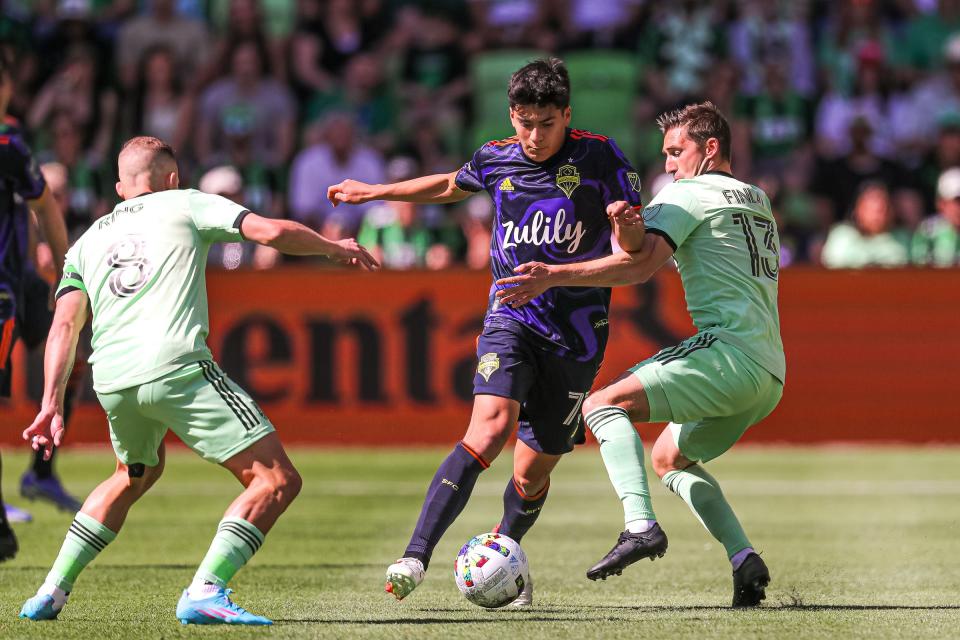 Seattle Sounders FC midfielder Obed Vargas, center, pushes past Austin FC midfielders Alex Ring, left, and Ethan Finlay during Austin's 1-1 draw Sunday at Q2 Stadium.