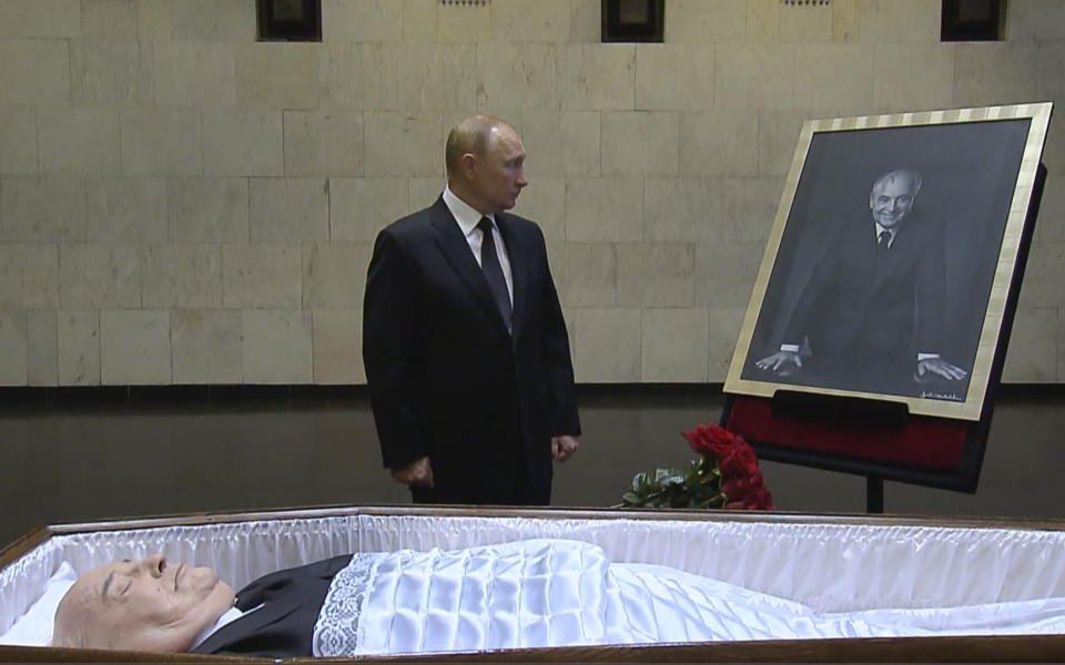 In this image taken from video provided by the Russian pool television on Thursday, Sept. 1, 2022, Russian President Vladimir Putin pays his last respect near the coffin of former Soviet President Mikhail Gorbachev at the Central Clinical Hospital in Moscow Russia. (Russian pool via AP)