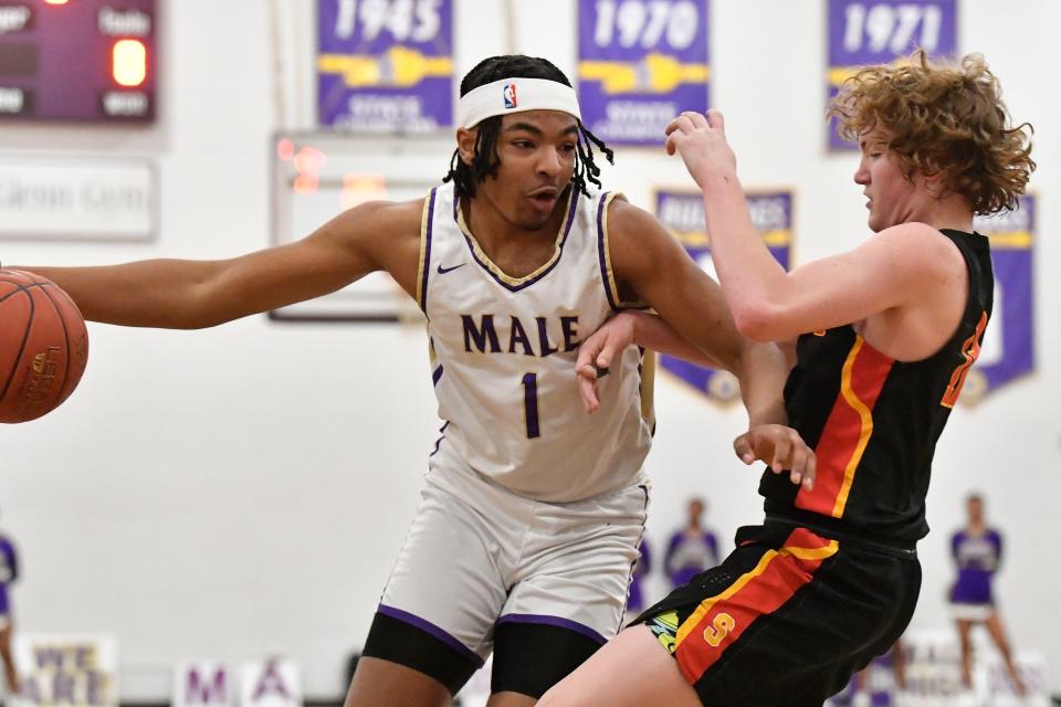 Male Keashawn Jordan (1) tries to pass Seneca's Preston Wheatley (12) during the first half of the game, Monday, January 8, 2024, at Louisville Ky.