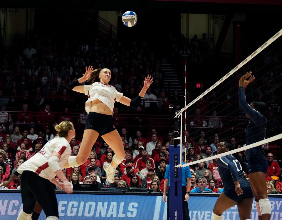 Wisconsin opposite hitter Anna Smrek goes high for a spike during the Badgers' Sweet 16 win over Penn State on Dec. 7. Smrek, who's 6-foot-9, forms an intimidating front line that also includes 6-4 hitter Sarah Franklin and 6-7 middle blocker Carter Booth.