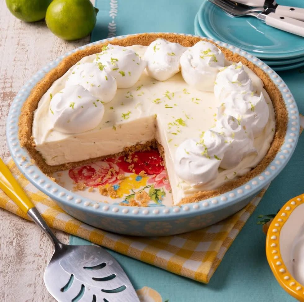 no bake key lime pie with dollops of whipped cream and lime zest