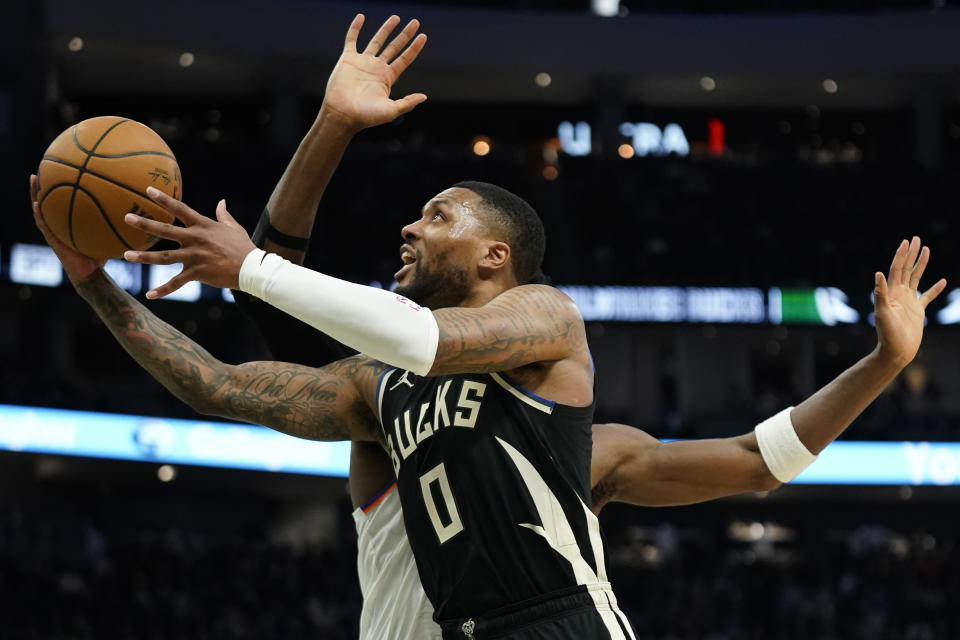 Milwaukee Bucks' Damian Lillard (0) shoots against New York Knicks' OG Anunoby during the second half of an NBA basketball game Sunday, April 7, 2024, in Milwaukee. (AP Photo/Aaron Gash)