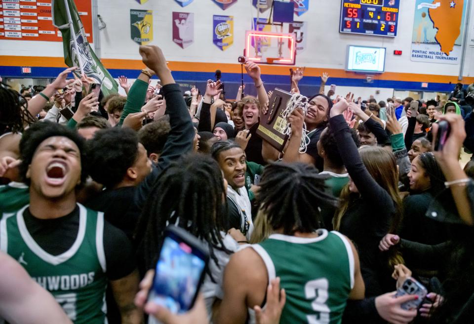 Fans mob the Richwoods Knights as they celebrate their 61-55 upset win over Metamora in the Class 3A sectional title game Friday, March 1, 2024 at Pontiac High School.