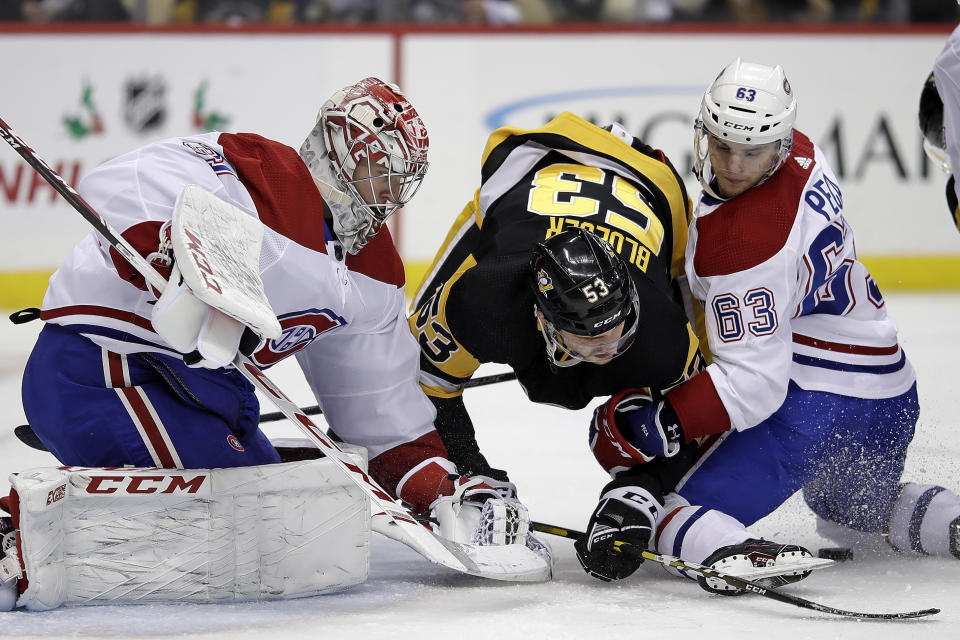 Pittsburgh Penguins' Teddy Blueger (53) can't get to a rebound off Montreal Canadiens goaltender Carey Price (31) with Matthew Peca (63) defending during the second period of an NHL hockey game in Pittsburgh, Tuesday, Dec. 10, 2019. (AP Photo/Gene J. Puskar)