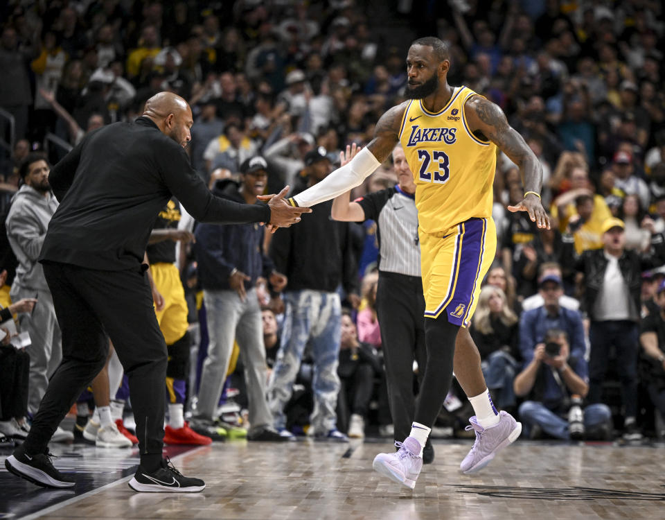 DENVER, CO - APRIL 22: LeBron James (23) of the Los Angeles Lakers celebrates earning a free throw, while making a shot with head coach Darvin Ham during the fourth quarter of the Denver Nuggets' 101-99 win at Ball Arena in Denver on Monday, April 22, 2024. (Photo by AAron Ontiveroz/The Denver Post)