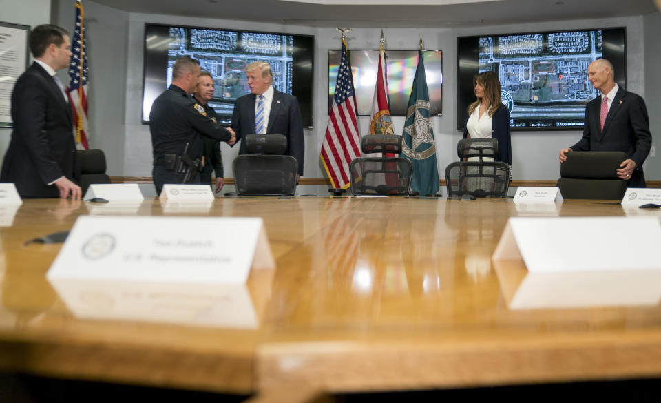 FILE - In this Feb. 16, 2018, file photo, President Donald Trump, third from right, shakes hands with Coconut Creek Police Officer Mike Leonard, second from left, as he meets with law enforcement officers at Broward County Sheriff's Office in Pompano Beach, Fla., following the shooting at Marjory Stoneman Douglas High School, in Parkland, Fla. Also pictured is Sen. Marco Rubio, R-Fla., left, Broward County Sheriff Scott Israel, second from left, first lady Melania Trump, second from right, and Florida Gov. Rick Scott, right. After flaming out in the GOP presidential primary _ and enduring rival Trump’s taunts along the way _ Rubio is entering his next act in politics. But one thing Rubio isn’t doing, he says, is gearing up for a White House run in 2020. And, he says no other Republicans should primary Trump either, because it could cost the GOP the presidency. (AP Photo/Andrew Harnik, File)