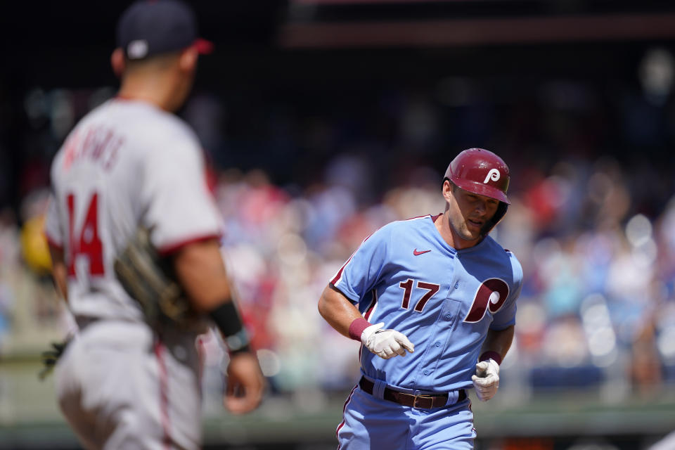 Philadelphia Phillies' Rhys Hoskins, right, runs the bases after hitting a two-run home run off of Washington Nationals relief pitcher Cory Abbott during the fourth inning of a baseball game, Sunday, Aug. 7, 2022, in Philadelphia. (AP Photo/Matt Rourke)