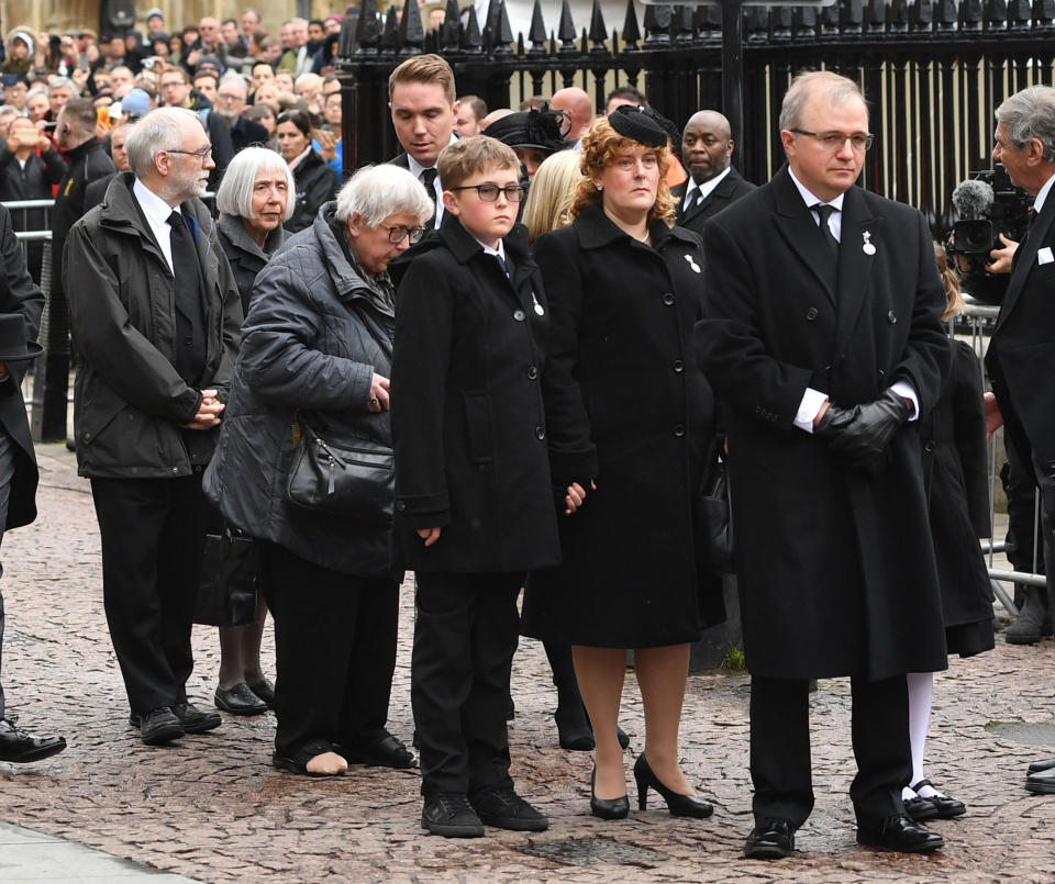 <p>Relatives and family members wait as the coffin of Professor Stephen Hawking is lifted from the hearse outside University Church of St Mary the Great in Cambridge for his funeral service in England on March 31, 2018. (Photo: Joe Giddens/PA Wire via ZUMA Press) </p>