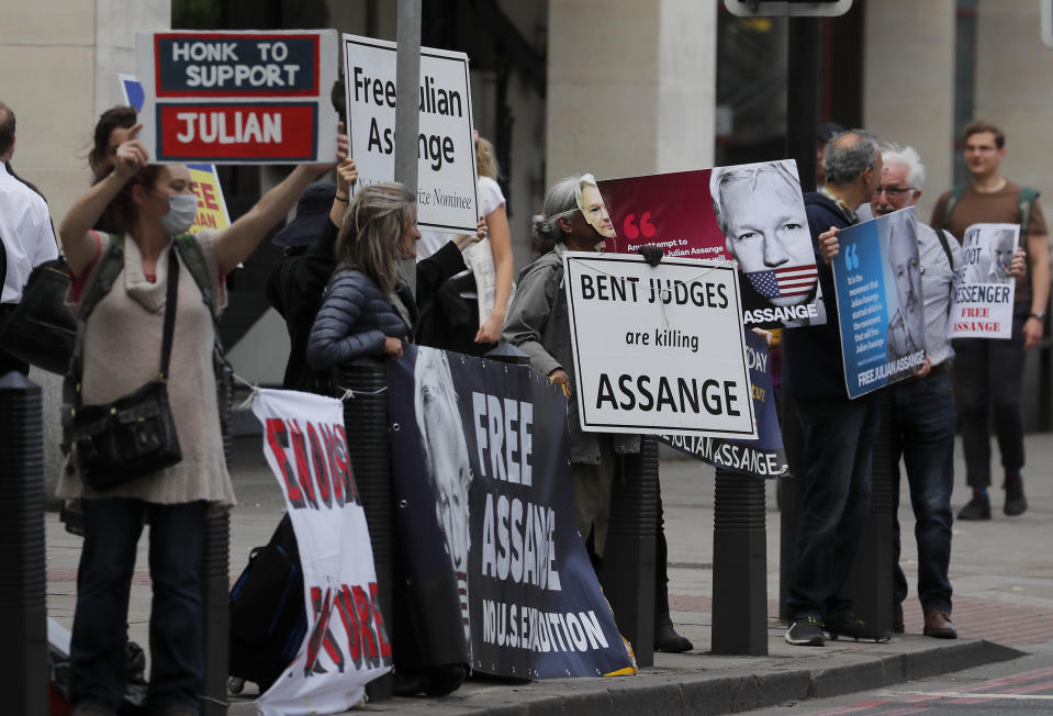 Supporters of WikiLeaks founder Julian Assange protest in front of Westminster Magistrates' Court in London, Monday, June 29, 2020, where he is expected to appear in custody for the extradition case management hearing. Assange was arrested last year after being evicted from the Ecuadorian Embassy in London, where he had sought refuge to avoid being sent to Sweden over allegations of rape and sexual assault, and is at the center of an extradition tussle over whether he should be sent to the United States. (AP Photo/Frank Augstein)