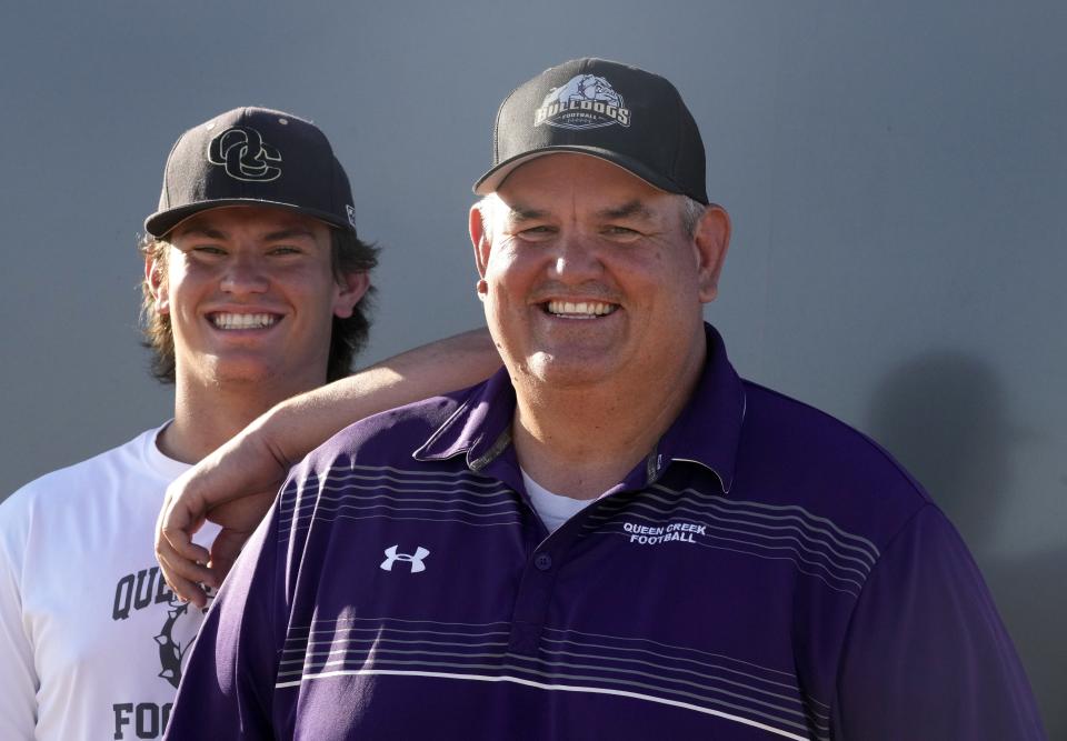 Jun 15, 2022; Mesa, AZ, USA;  Queen Creek Griffin Schureman offensive lineman, left,  poses with his dad head Queen Creek coach Travis Schureman.