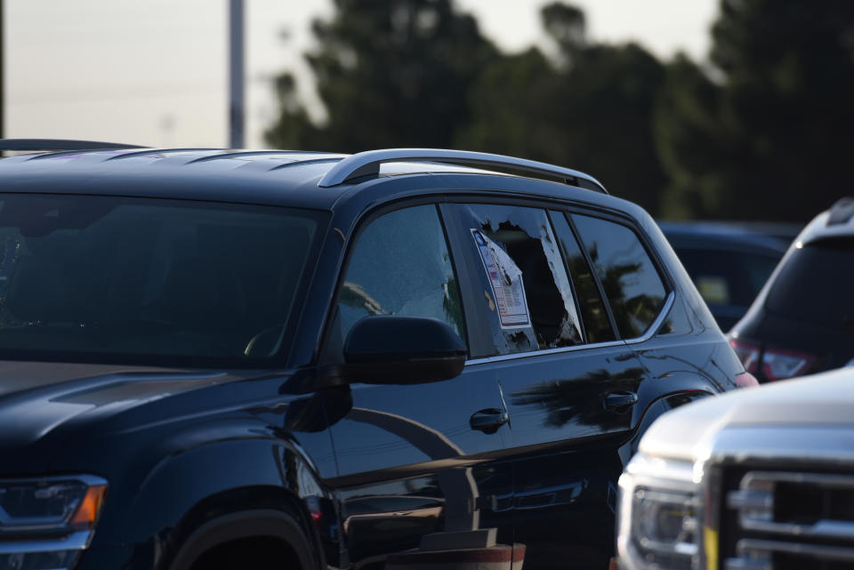 A vehicle with a broken window is seen as Texas state troopers and other emergency personnel monitor the scene at a local car dealership following a shooting in Odessa, Texas, U.S. September 1, 2019. REUTERS/Callaghan O'Hare