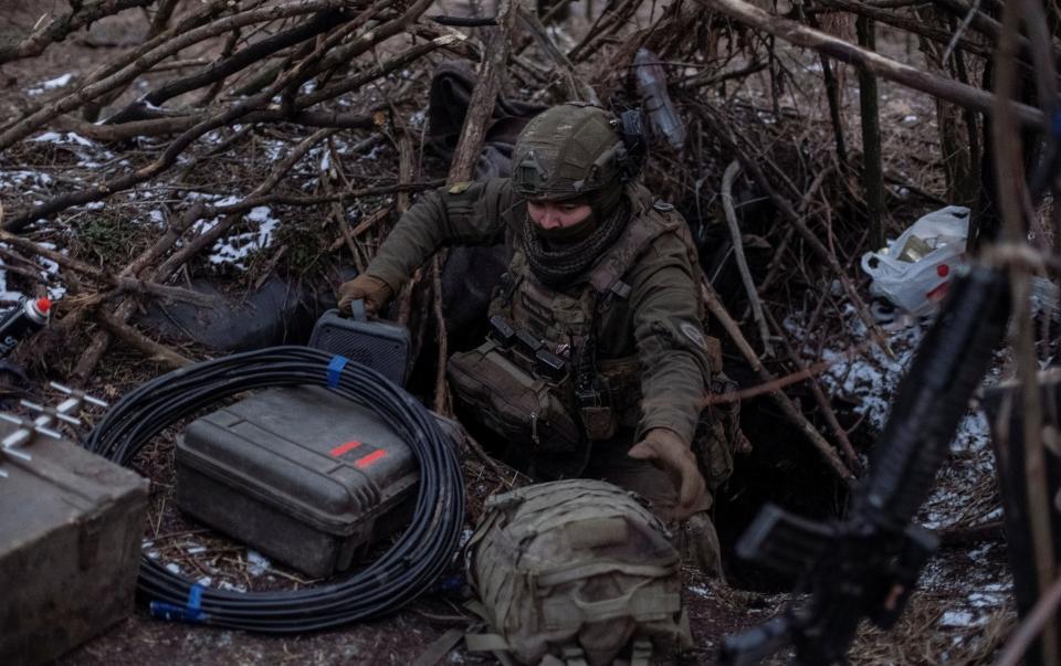 A Ukrainian serviceman of 47th brigade prepares his position to operate a drone at a front line near Avdiivka