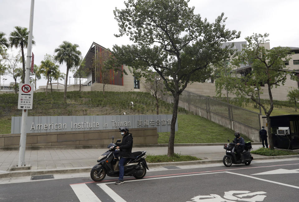 Riders wait for a traffic light in front of American Institute in Taiwan, or AIT in Taipei, Taiwan, Wednesday, Nov. 10, 2021. The U.S. has strong but informal relations with Taiwan, and tensions have been rising between the U.S. and China over several issues including Hong Kong, the South China Sea, the coronavirus pandemic and trade. (AP Photo/Chiang Ying-ying)