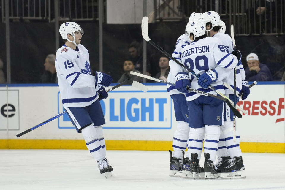 Toronto Maple Leafs Calle Jarnkrok, left, celebrates with teammates after a goal by Conor Timmins during the first period of an NHL hockey game against the New York Rangers, Tuesday, Dec. 12, 2023, in New York. (AP Photo/Seth Wenig)