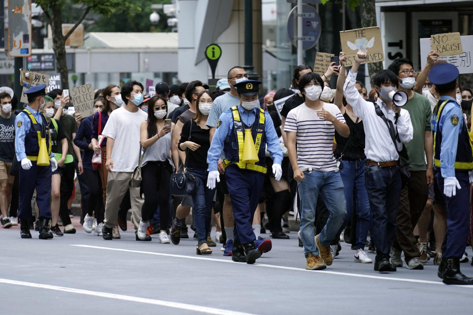 People march to protest during a solidarity rally for the death of George Floyd and against racism Saturday, June 6, 2020, in Tokyo. Floyd died after being restrained by Minneapolis police officers on May 25. (AP Photo/Eugene Hoshiko)
