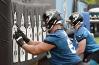 Jacksonville Jaguars center Tyler Shatley, left, performs a drill during an NFL football practice, Monday, June 14, 2021, in Jacksonville, Fla. (AP Photo/John Raoux)