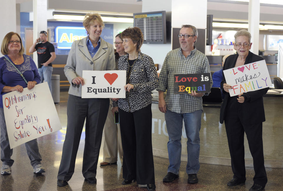 Oklahomans for Equality gather at Tulsa International Airport with their signs for a send off celebration in support for the plaintiffs in the Oklahoma Marriage Equality lawsuit as they head to the 10th Circuit Court of Appeals in Denver, Wednesday April 16, 2014. (AP Photo/Brandi Simons)