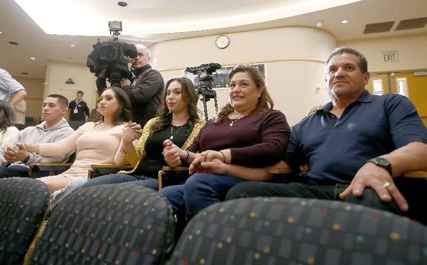 FILE - In this Dec. 8, 2016, file photo, from left to right: The Sandoval family, brother Emilio, sister Aniza, sister Esmerelda, mother Aida, and father Arturo hold hands during a news conference about the surgery on conjoined twins Erika and Eva Sandoval, at the Lucile Packard Children's Hospital in Palo Alto, Calif. Formerly conjoined twins Eva and Erika Sandoval have left Lucile Packard Children's Hospital Stanford and will be headed home in a few weeks. The 2 1/2-year-old Sacramento area girls, who were born conjoined from the chest down, were separated on Dec. 6 at the hospital. They were moved from Palo Alto to UC Davis Children's Hospital in Sacramento Thursday, March 9, 2017. There, they will receive a few weeks of inpatient rehabilitation before returning to their family's home. (AP Photo/Tony Avelar, File)