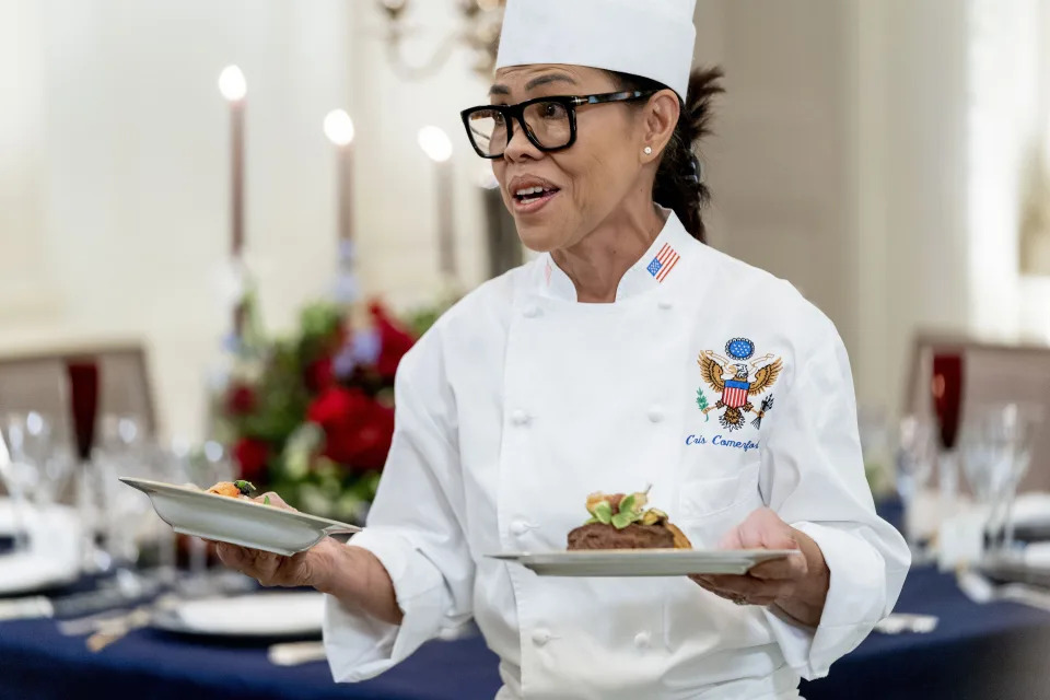 FILE - White House executive chef Cris Comerford, holds dishes as she speaks during a media preview for the State Dinner with President Joe Biden and French President Emmanuel Macron in the State Dining Room of the White House in Washington, Nov. 30, 2022. Comerford has retired after nearly three decades of making meals and cooking up state dinners for five different presidents and their families. (AP Photo/Andrew Harnik, File)