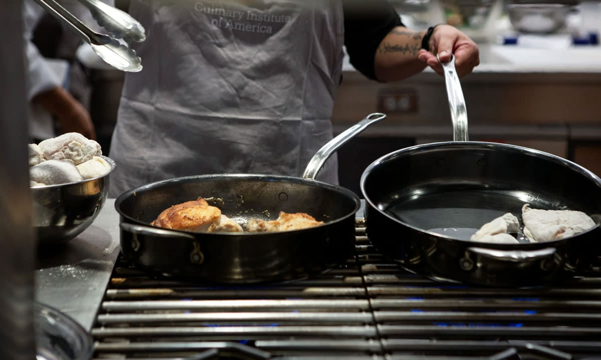 This is a photo of a chef cooking in a kitchen.