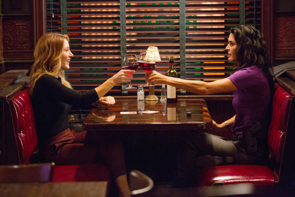 Isles and Rizzoli clinking glasses