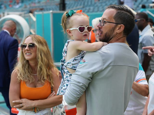 <p>Peter Joneleit/Icon Sportswire/Getty</p> Mike McDaniel with his wife Katie and daughter Alya June