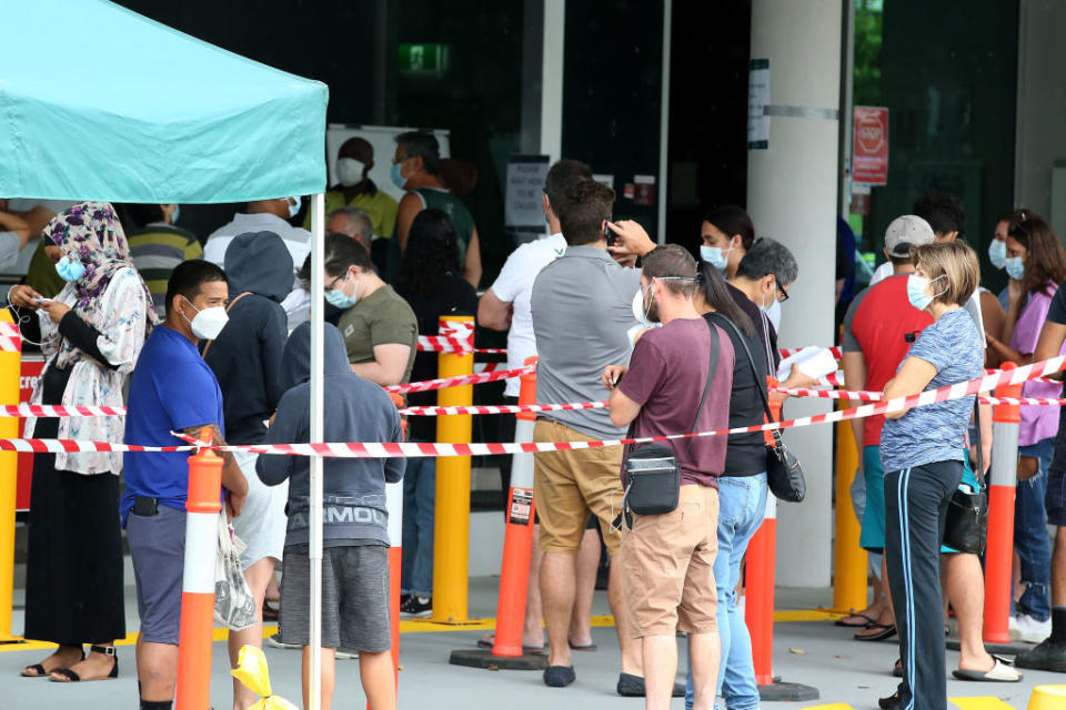 Residents line up outside a 24-hour COVID testing clinic south of Brisbane.