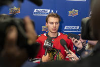 FILE - Chicago Blackhawks hockey player Connor Bedard, the number one overall draft pick, talks with reporters during the NHL Players Association rookie showcase, Tuesday, Sept. 5, 2023 in Arlington, Va. Bedard is the most hyped hockey player since Connor McDavid. He's just not the only rookie worth watching this NHL season. (AP Photo/Alex Brandon, File)