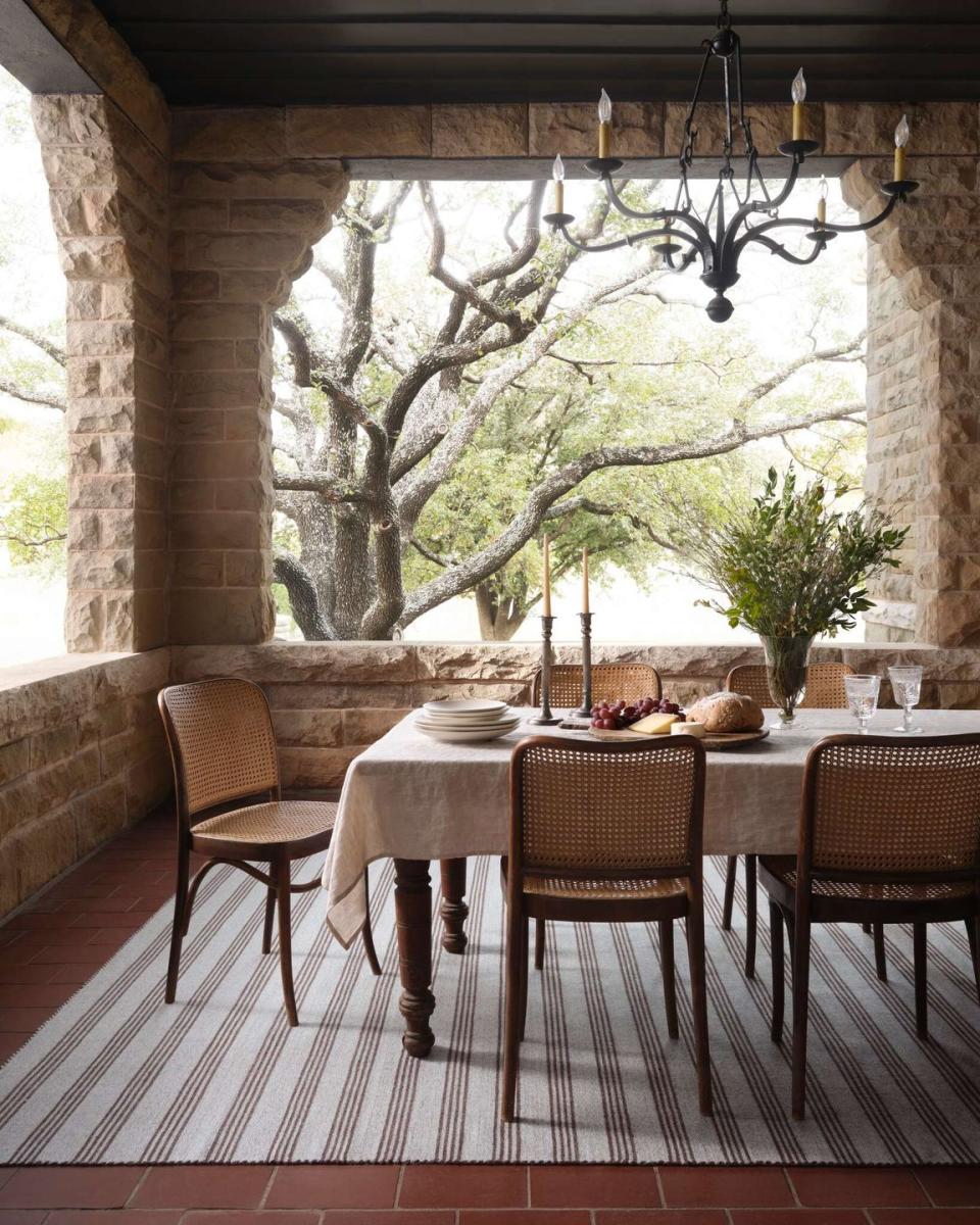 a table with chairs and a plant