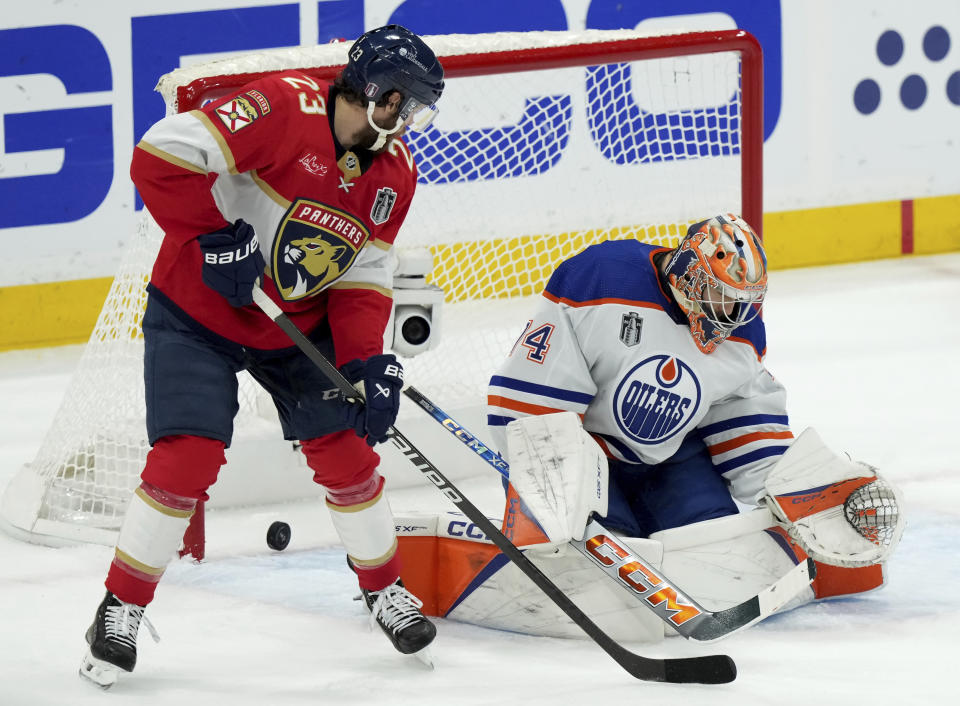 Florida Panthers forward Carter Verhaeghe (23) scores on Edmonton Oilers goaltender Stuart Skinner (74) during the first period of Game 7 of the NHL hockey Stanley Cup Final on Monday, June 24, 2024, in Sunrise, Fla. (Nathan Denette/The Canadian Press via AP)