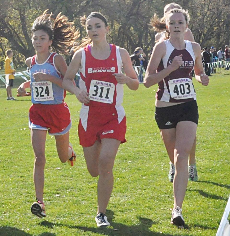 Britton-Hecla senior Kelsey Barrett (311) became the third female runner in state history to win four individual state cross country titles when she won the Class A girls’ 4,000-meter race in October of 2011. She won a close battle against a field of runners that included Savannah Childers of Spearfish (403) and Destiny Beautiful Bald Eagle of Cheyenne-Eagle Butte.