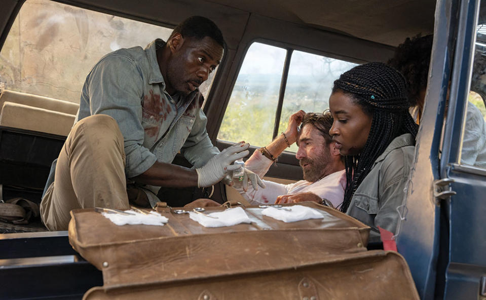 A scene from Beast featuring (from left) Idris Elba, Sharlto Copley and Iyana Halley.