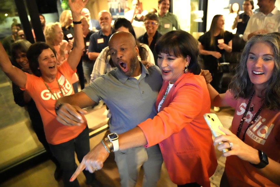Tempe City Council candidate Doreen Garlid celebrates early results with Mayor Corey Woods and supporters during a watch party at her home in Tempe on March 12, 2024.