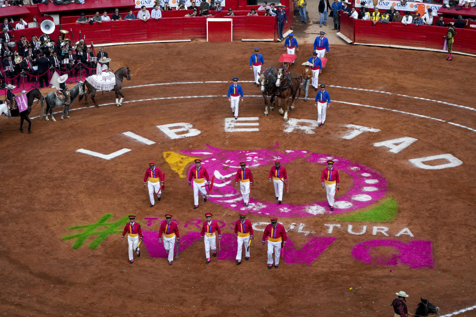 bullfighters assistants parade during a bullfight at the Plaza Mexico, in Mexico City, Sunday, Jan. 28, 2024. Bullfighting returned to Mexico City after the Supreme Court of Justice overturned a 2022 ban that prevented these events from taking place in the capital. (AP Photo/Fernando Llano)