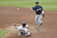 Jun 5, 2018; Cleveland, OH, USA; Milwaukee Brewers shortstop Orlando Arcia (3) turns a double play beside Cleveland Indians right fielder Lonnie Chisenhall (8) in the second inning at Progressive Field. Mandatory Credit: David Richard-USA TODAY Sports