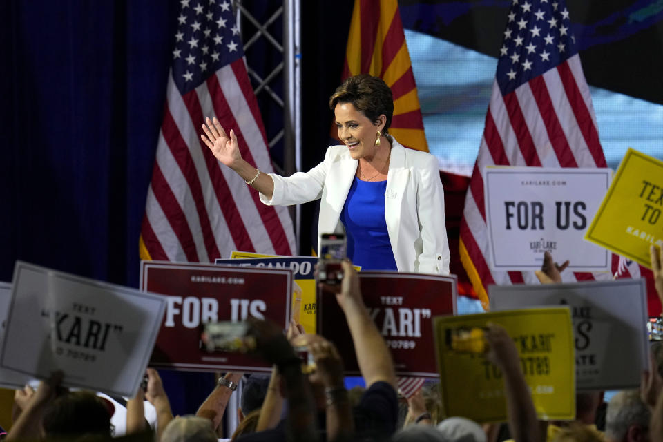 Republican candidate Kari Lake waves to supporters as she arrives on stage to announce her plans to run for the Arizona U.S. Senate seat during a rally, Tuesday, Oct. 10, 2023, in Scottsdale, Ariz. (AP Photo/Ross D. Franklin)