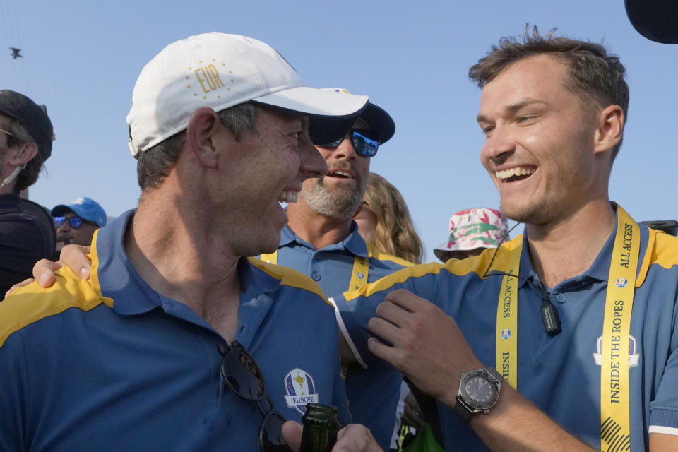Europe's Rory McIlroy, left celebrates with Europe's Nicolai Hojgaard after Europe won the Ryder Cup after the end of the singles matches at the Ryder Cup golf tournament at the Marco Simone Golf Club in Guidonia Montecelio, Italy, Sunday, Oct. 1, 2023. (AP Photo/Gregorio Borgia )
