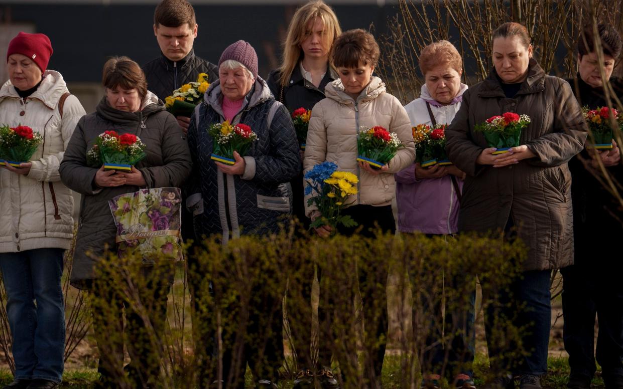 Relatives of those killed during the Russian occupation attend a commemoration of the victims