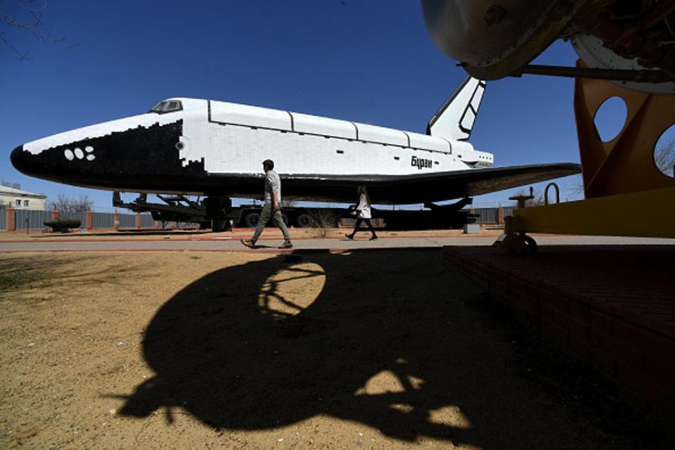 People walk close to one of the Soviet era space shuttles Buran installed in a museum at Russian-leased Baikonur Cosmodrome in Kazakhstan (AFP via Getty Images)