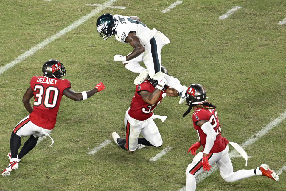 Philadelphia Eagles' D'Andre Swift (0) tries to get past Tampa Bay Buccaneers' Antoine Winfield Jr. (31) during the second half of an NFL football game, Monday, Sept. 25, 2023, in Tampa, Fla. (AP Photo/Jason Behnken)